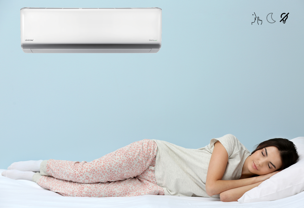 Στη φωτογραφία απεικονίζεται μία γυναίκα ξαπλωμένη και το κλιματιστικό τοποθετημένο σε δωμάτιο